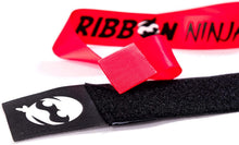 Load image into Gallery viewer, Fat Brain Toys Ribbon Ninja - The High Speed Game of Quick and Clever Reflexes Fun Active Indoor Outdoor Family Competition Game for Kids, Teens, &amp; Adults